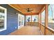 Inviting covered porch featuring natural wood ceiling, ceiling fan, and access to the outdoors, perfect for relaxation at 1659 Olympian Sw Way, Atlanta, GA 30310