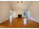 Spacious living room featuring gleaming hardwood floors, a fireplace with white mantle, and large windows for natural light at 246 Southern Oaks Dr, Dallas, GA 30157