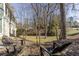 A relaxing backyard setting with mature trees and Adirondack chairs, perfect for outdoor enjoyment at 1742 Dunridge Ct, Dunwoody, GA 30338