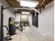 Basement area featuring exposed ceiling with hanging punching bag and white-painted cinderblock walls at 1742 Dunridge Ct, Dunwoody, GA 30338