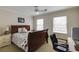 Bedroom featuring a sleigh bed, ceiling fan, and two windows at 1742 Dunridge Ct, Dunwoody, GA 30338