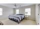 Bedroom featuring a bed with striped bedding, lamp on the nightstand, and carpeted floor at 1742 Dunridge Ct, Dunwoody, GA 30338