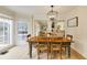 Charming dining room with a rustic table, pendant lighting, and large windows at 1742 Dunridge Ct, Dunwoody, GA 30338
