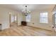 Elegant dining room featuring hardwood floors, wainscoting, and a modern chandelier at 1742 Dunridge Ct, Dunwoody, GA 30338