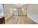 Elegant dining room featuring hardwood floors, wainscoting, and a modern chandelier at 1742 Dunridge Ct, Dunwoody, GA 30338
