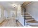 Inviting foyer with light wood floors, a staircase, and a bench at 1742 Dunridge Ct, Dunwoody, GA 30338