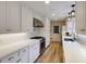Well-lit kitchen featuring white cabinets, stainless appliances, and a sink with window view at 1742 Dunridge Ct, Dunwoody, GA 30338