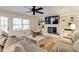 Bright living room featuring a fireplace, built-in shelving, and a comfortable sectional sofa at 1742 Dunridge Ct, Dunwoody, GA 30338