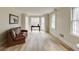 Bright living room featuring bay windows, hardwood floors, and a comfortable leather couch at 1742 Dunridge Ct, Dunwoody, GA 30338