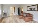 Bright living room featuring hardwood floors, a comfortable leather couch and stylish décor at 1742 Dunridge Ct, Dunwoody, GA 30338