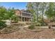 Picturesque backyard showcasing a spacious porch, beautifully landscaped garden, and mature trees at 180 Winecoff Dr, Fayetteville, GA 30214