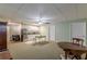 Expansive basement area features a kitchenette, white cabinets and carpeted flooring at 180 Winecoff Dr, Fayetteville, GA 30214