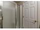 Shower stall with frosted glass door, next to a closed door with brass hardware at 180 Winecoff Dr, Fayetteville, GA 30214