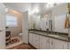 Spacious bathroom with double granite vanity, bright lighting and neutral colored tiling at 180 Winecoff Dr, Fayetteville, GA 30214