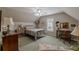 Cozy bedroom with a comfortable bed, wood desk, and bright natural light at 180 Winecoff Dr, Fayetteville, GA 30214