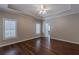 Bedroom with hardwood floors, ceiling fan, trey ceiling, and window shutters at 180 Winecoff Dr, Fayetteville, GA 30214