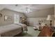 Comfortable bedroom with neutral tones, complemented by a ceiling fan and a cozy reading nook at 180 Winecoff Dr, Fayetteville, GA 30214