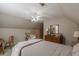 Inviting bedroom featuring a queen-size bed, ceiling fan, and a classic wooden dresser at 180 Winecoff Dr, Fayetteville, GA 30214