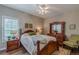 Cozy bedroom with hardwood floors, a ceiling fan, and plantation shutters at 180 Winecoff Dr, Fayetteville, GA 30214