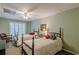 Cozy bedroom featuring two beds, a ceiling fan, and soft natural light, creating a comfortable atmosphere at 180 Winecoff Dr, Fayetteville, GA 30214