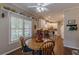 Light-filled breakfast nook with hardwood floors and a view into the kitchen at 180 Winecoff Dr, Fayetteville, GA 30214