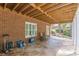 Charming covered patio with stone flooring, exposed wood beams, and comfortable seating area at 180 Winecoff Dr, Fayetteville, GA 30214