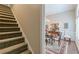 Dining area next to stairs with hardwood floors and shuttered windows at 180 Winecoff Dr, Fayetteville, GA 30214