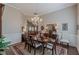 Formal dining room features a chandelier, wainscoting, and a view into the living room at 180 Winecoff Dr, Fayetteville, GA 30214
