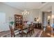 Elegant dining room featuring a large table, chandelier, and hardwood floors at 180 Winecoff Dr, Fayetteville, GA 30214