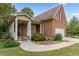 Charming brick home with a covered front porch and well-maintained landscaping at 180 Winecoff Dr, Fayetteville, GA 30214