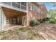 Brick home featuring a large screened porch and covered patio, complemented by a meticulously landscaped yard at 180 Winecoff Dr, Fayetteville, GA 30214