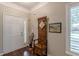 Inviting foyer featuring hardwood floors, vintage coat rack and adjacent to a window with shuttered blinds at 180 Winecoff Dr, Fayetteville, GA 30214
