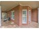 Covered front porch with tile flooring and a comfortable seating area at 180 Winecoff Dr, Fayetteville, GA 30214