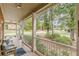 Covered front porch featuring white columns, railings, and a view of the surrounding neighborhood at 180 Winecoff Dr, Fayetteville, GA 30214