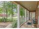 Spacious covered porch with columns, railing, and view of the landscaped front yard at 180 Winecoff Dr, Fayetteville, GA 30214