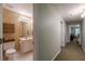 Hallway with bathroom and bedrooms. Bathroom features toilet and sink with mirror at 180 Winecoff Dr, Fayetteville, GA 30214