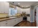 Bright kitchen features white cabinets, stainless steel appliances, and hardwood floors at 180 Winecoff Dr, Fayetteville, GA 30214