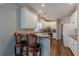 Bright kitchen with white cabinets, stone countertops, and hardwood floors, perfect for culinary enthusiasts at 180 Winecoff Dr, Fayetteville, GA 30214