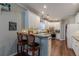 Eat-in kitchen boasts white cabinets, granite counters, stainless appliances, and hardwood floors at 180 Winecoff Dr, Fayetteville, GA 30214