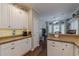 Bright kitchen featuring white cabinetry, ample counter space, and open breakfast area at 180 Winecoff Dr, Fayetteville, GA 30214