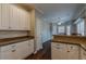 Well-lit kitchen with white cabinetry, breakfast bar, stone countertops, and hardwood floors, a great space at 180 Winecoff Dr, Fayetteville, GA 30214