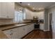 Charming kitchen featuring white cabinetry, stone countertops, and modern appliances, offering a functional design at 180 Winecoff Dr, Fayetteville, GA 30214