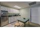 Kitchenette with stainless steel refrigerator and white cabinets at 180 Winecoff Dr, Fayetteville, GA 30214