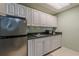 Kitchenette with stainless steel refrigerator and granite countertop at 180 Winecoff Dr, Fayetteville, GA 30214