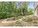 Beautifully landscaped garden area, with winding pathways, mature trees, and decorative rock features at 180 Winecoff Dr, Fayetteville, GA 30214