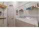 Clean laundry room with white washer and dryer and wire shelving at 180 Winecoff Dr, Fayetteville, GA 30214