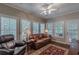 Bright living room with natural light, leather seating and wood floors at 180 Winecoff Dr, Fayetteville, GA 30214