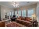 Living room with a large leather couch, wood floors, and natural light at 180 Winecoff Dr, Fayetteville, GA 30214