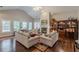 Living room with fireplace, sofas and bright windows with shutters at 180 Winecoff Dr, Fayetteville, GA 30214