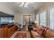 Spacious living room with wood floors, a large TV, and comfortable seating at 180 Winecoff Dr, Fayetteville, GA 30214